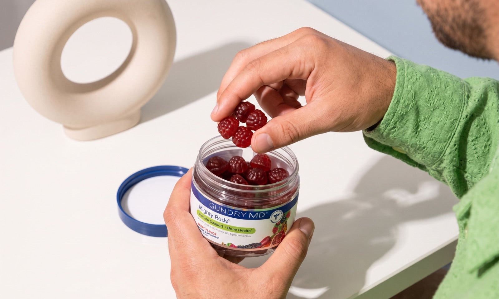 Mighty Reds gummies being taken from the jar